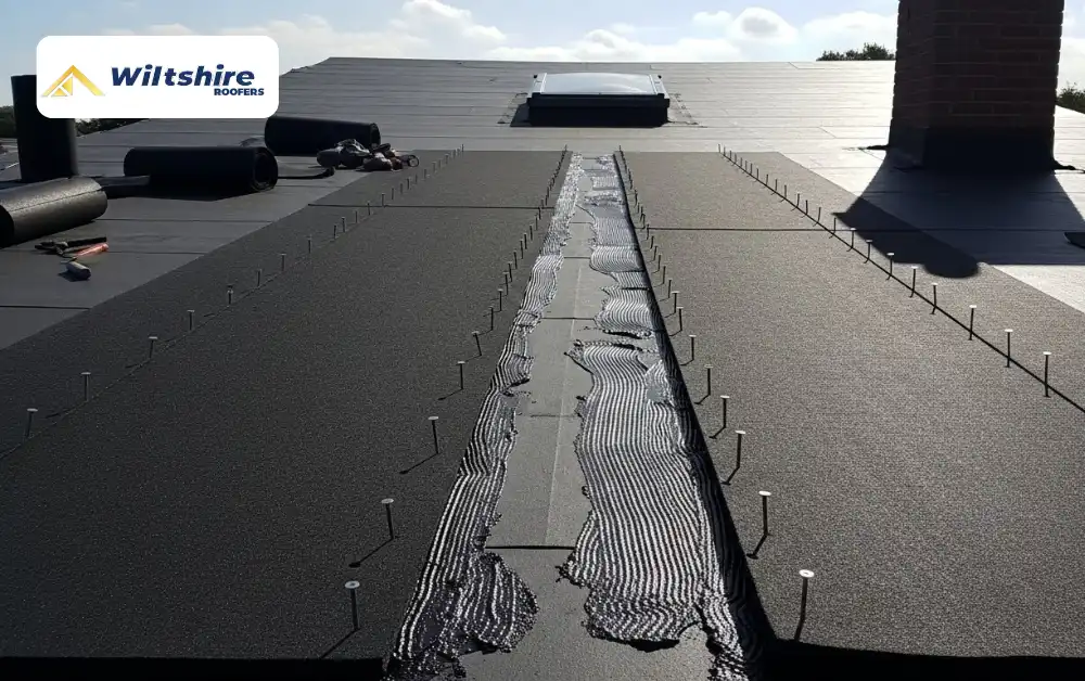 Adding additional layers of felt for extra protection on a felt flat roof